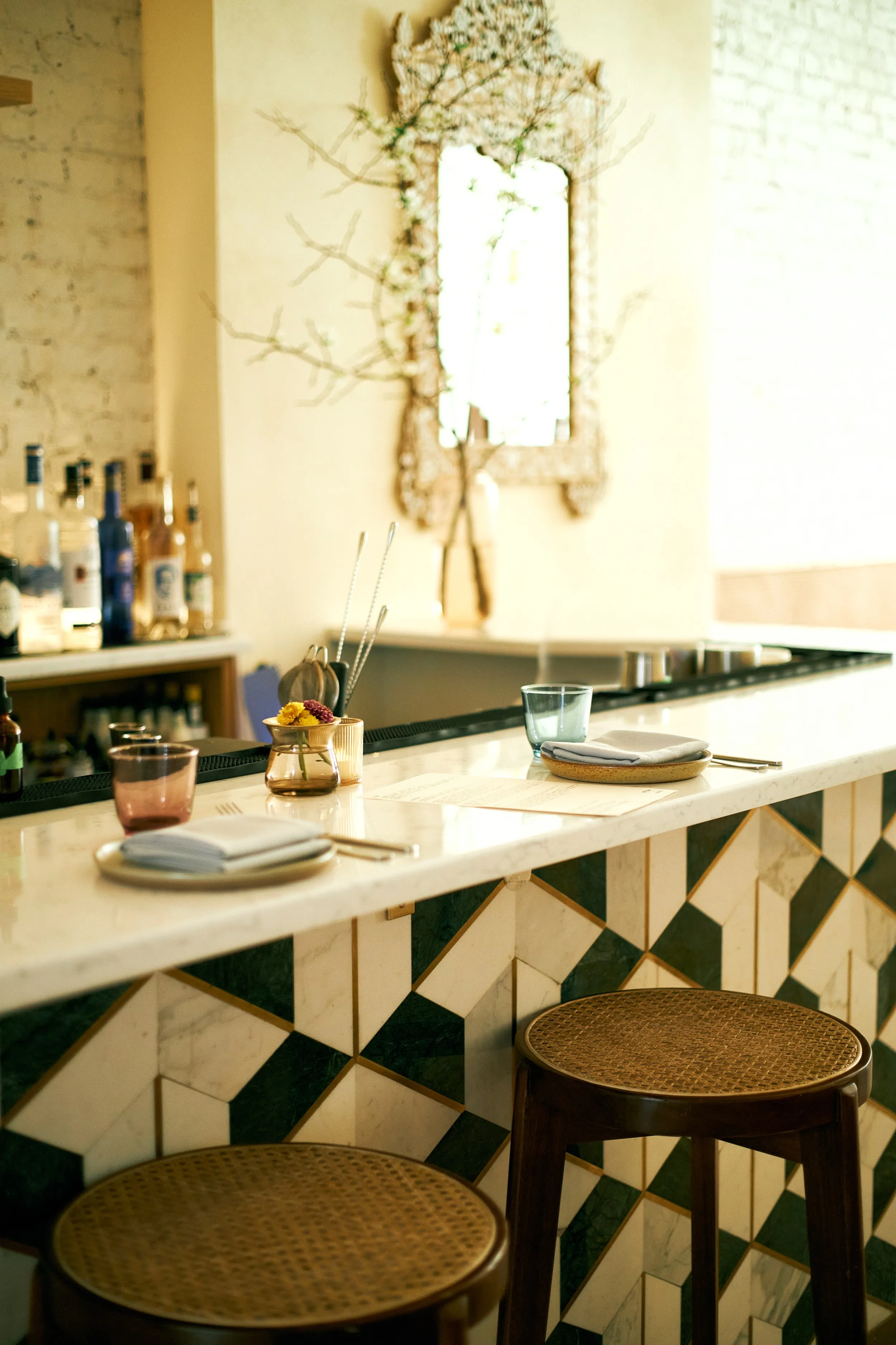 The bar at Sawa, with its mirrored back wall and warm light